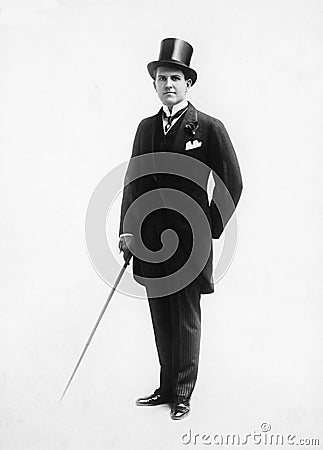 Portrait of a man in a top hat and morning suit holding a cane Stock Photo