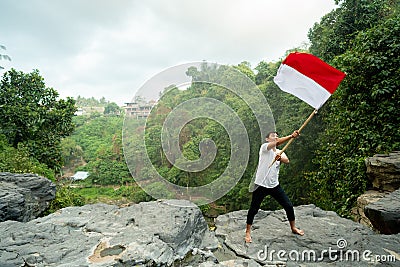 Asian male with indonesian flag celebrating independence day Stock Photo