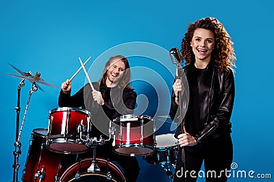 Portrait of man two woman popular artist punk musician play drum drumstick sing song enjoy festival tour night club Stock Photo