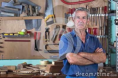 Portrait of man at work in workshop in garage at home Stock Photo