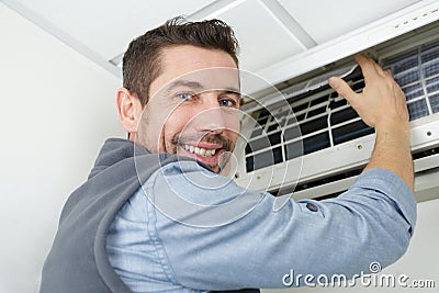 Portrait man working on air-conditioned system Stock Photo