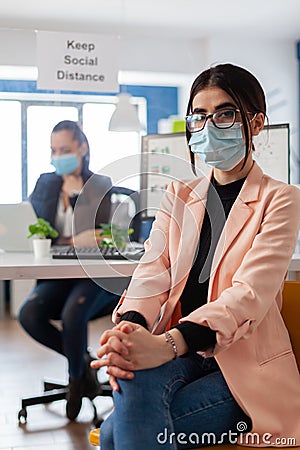 Portrait of manager entrepreneur with face mask as safety precation Stock Photo