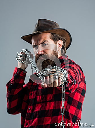 Portrait of masculinity. male casual fashion style. handsome hipster with cowboy hat hold chain Stock Photo
