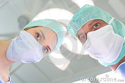 Portrait masked medical workers leaning forwards Stock Photo