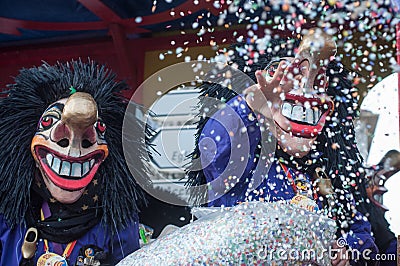 Portrait of masked person parading in the street throwing confetti Editorial Stock Photo