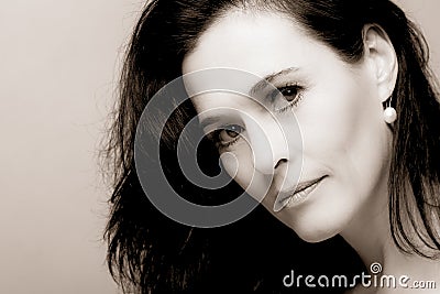 Portrait of a mature brunette woman sitting and contemplates realities of life Stock Photo