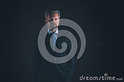 Portrait of a mature businessman on black background Stock Photo