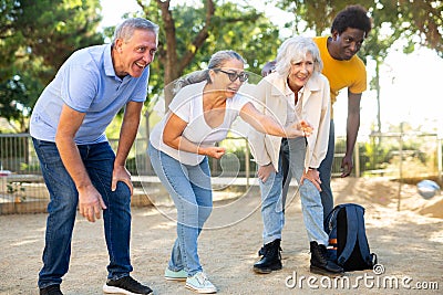 Portrait of mature couples playing petanque at leisure Stock Photo