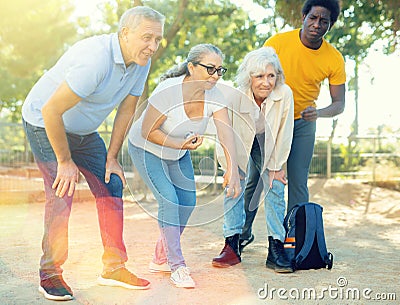 Portrait of mature couples playing petanque at leisure Stock Photo