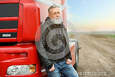 Portrait of mature driver at modern truck outdoors Stock Photo