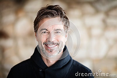 Portrait Of A Mature Men Smiling At The Camera At Home Stock Photo