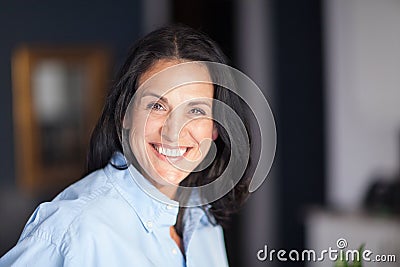 Portrait Of A Mature Spanish woman Smiling At The Camera. At The Office Stock Photo