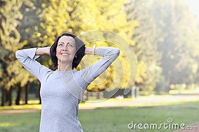 Portrait of mature woman before or after jog in the park Stock Photo