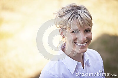 Portrait Of A Mature Woman Smiling Outside Stock Photo