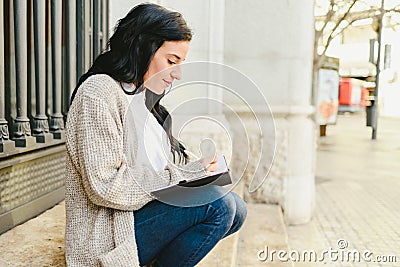 Portrait mature woman taking notes in her notebook, pointing her dreams and future plans Stock Photo