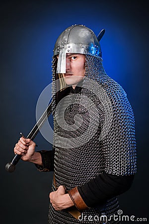 Portrait of a medieval warrior of the late Viking era and the beginning of the Crusades. Knight in chain mail and helmet Stock Photo