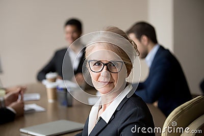 Portrait of middle aged businesswoman posing during briefing Stock Photo