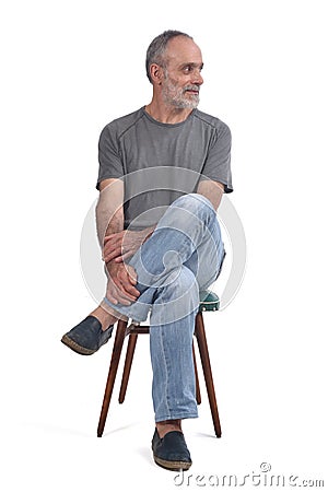 Portrait of middle aged man sitting on white Stock Photo