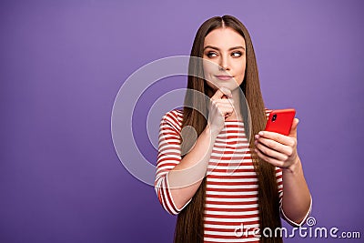 Portrait minded cunning curious girl use smartphone look copyspace touch chin hand plan write incredible followers Stock Photo