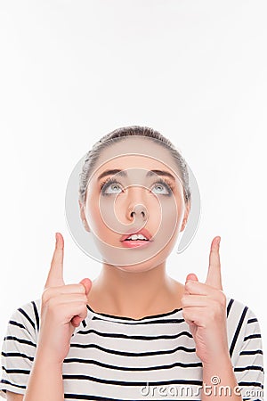 Portrait of minded girl pointing up with open mouth Stock Photo