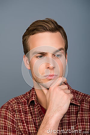 Portrait of minded handsome man touching his chin Stock Photo