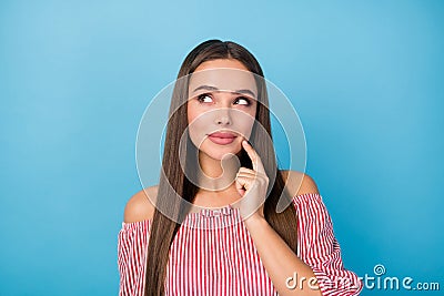 Portrait of minded interested girl touch finger cheek look copyspace wear modern stylish shirt isolated blue color Stock Photo