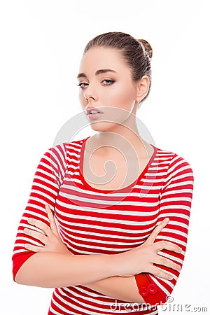 Portrait of minded serious young woman with crossed hands Stock Photo
