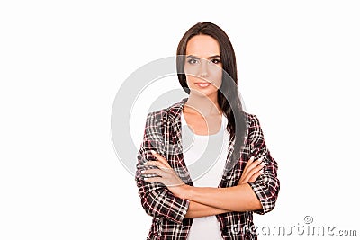 Portrait of minded young woman in checkered shirt with crossed hands Stock Photo