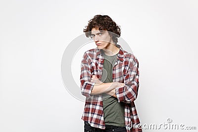 Portrait of mistrustful puzzled young man in casual clothes holding hands crossed looking camera isolated on white Stock Photo