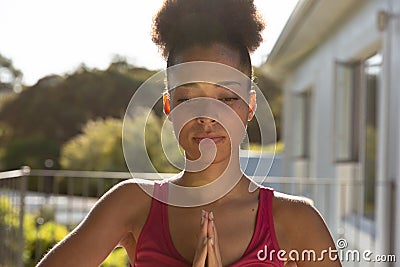 Portrait of mixed race woman exercising practicing yoga on a terrace Stock Photo