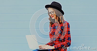 Portrait of modern young woman in casual working with laptop Stock Photo