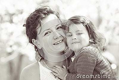 Portrait of mother and daughter kissing laughing Stock Photo