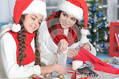 Portrait of mother and her daughter making decorations Stock Photo