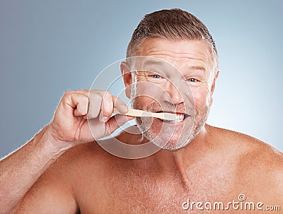 Portrait, mouth or old man brushing teeth with dental toothpaste for healthy oral hygiene grooming in studio. Eco Stock Photo