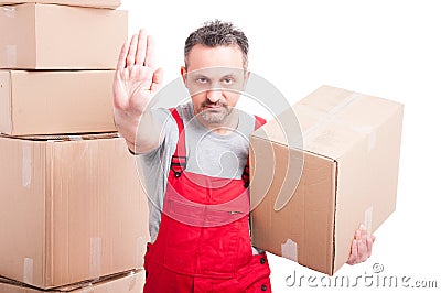 Portrait of mover man holding box showing stop gesture Stock Photo