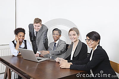 Portrait of multiethnic professionals using laptop at conference room Stock Photo