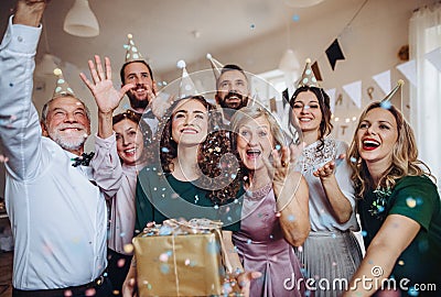 A portrait of multigeneration family with presents on a indoor birthday party. Stock Photo