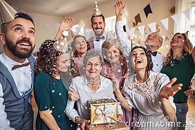 A portrait of multigeneration family with presents on a indoor birthday party. Stock Photo