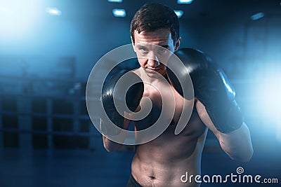 Portrait of muscular boxer in black gloves Stock Photo