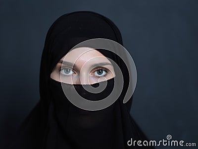 Portrait of muslim woman wearing niqab and traditional arabic clothes or abaya Stock Photo