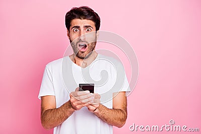 Portrait of negative addicted shocked funky middle eastern man hold use smartphone read got notification dislike scream Stock Photo