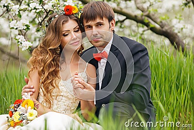 Portrait newlyweds in the lush spring garden Stock Photo