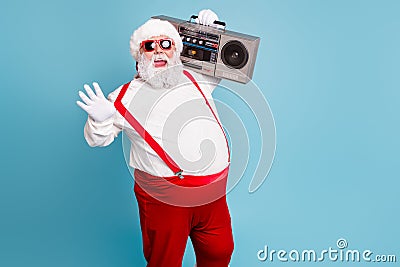 Portrait of nice bearded cheerful funky funny glad big belly Santa carrying tape player having fun isolated over bright Stock Photo