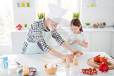 Portrait of nice cheerful grey-haired granddad teaching grandchild learning cook fresh delicious dish meal kneading Stock Photo