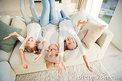 Portrait of nice cute attractive adorable charming lovely cheerful cheery people rejoicing upside-down in modern light Stock Photo