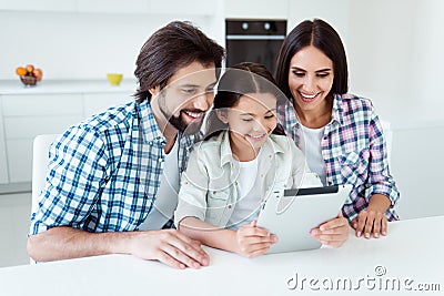 Portrait of nice cute attractive cheerful cheery positive people mom dad spending time using new gadget device reading e Stock Photo