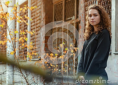 Portrait of a nice girl with curly hair in a dark jacket Stock Photo