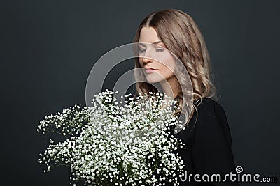 Portrait of nice woman with white flowers on black background Stock Photo