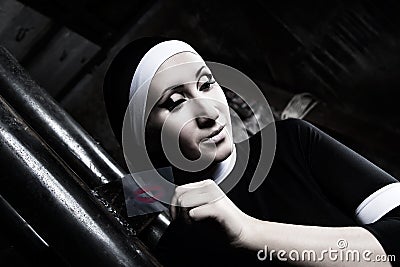 portrait of a nun in black clothes with a kiss imprint in sinful thoughts Stock Photo