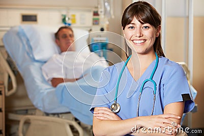 Portrait Of Nurse With Patient In Background Stock Photo